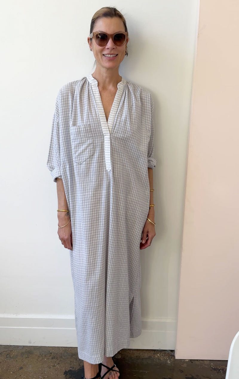 Grey and white check handwoven cotton fabric in a long sleeve, long caftan dress with a single breast pocket